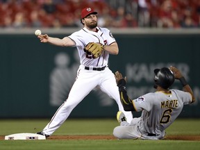 Pittsburgh Pirates' Starling Marte (6) is out at second as Washington Nationals second baseman Daniel Murphy, left, throws to first to get out Andrew McCutchen to complete a double-play during the first inning of a baseball game, Thursday, Sept. 28, 2017, in Washington. (AP Photo/Nick Wass)
