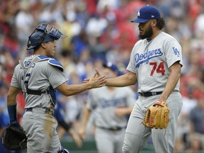 Los Angeles Dodgers relief pitcher Kenley Jansen (74) celebrates with catcher Austin Barnes, left, after a baseball game against the Washington Nationals, Saturday, Sept. 16, 2017, in Washington. The Dodgers won 3-2. (AP Photo/Nick Wass)