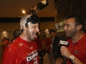 Washington Nationals Max Scherzer, left, is doused as he is interviewed in the locker room as the team celebrates after they clinched the National League East title after a baseball game against the Philadelphia Phillies, Sunday, Sept. 10, 2017, in Washington. (AP Photo/Nick Wass)