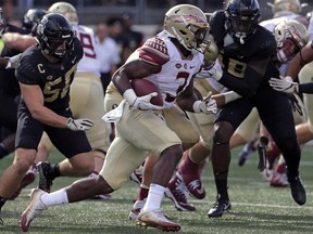 Florida State's Cam Akers (3) runs past Wake Forest's Grant Dawson (50) in the first half of an NCAA college football game in Winston-Salem, N.C., Saturday, Sept. 30, 2017. (AP Photo/Chuck Burton)