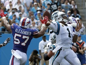 Carolina Panthers' Cam Newton (1) looks to pass under pressure from Buffalo Bills' Lorenzo Alexander (57) in the first half of an NFL football game in Charlotte, N.C., Sunday, Sept. 17, 2017. (AP Photo/Bob Leverone)