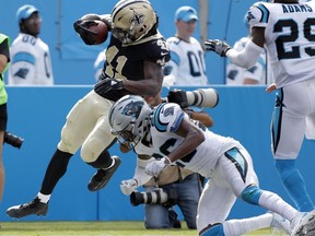 New Orleans Saints' Alvin Kamara (41) runs for a touchdown as Carolina Panthers' Daryl Worley (26) defends in the second half of an NFL football game in Charlotte, N.C., Sunday, Sept. 24, 2017. (AP Photo/Bob Leverone)