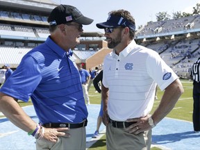 Duke coach David Cutcliffe, left, and North Carolina coach Larry Fedora speak prior to an NCAA college football game in Chapel Hill, N.C., Saturday, Sept. 23, 2017. (AP Photo/Gerry Broome)