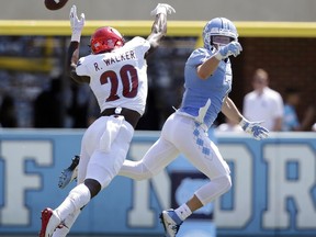 Louisville's Ronald Walker (20) and North Carolina's Austin Proehl reach for a pass intended for Proehl during the first half of an NCAA college football game in Chapel Hill, N.C., Saturday, Sept. 9, 2017. (AP Photo/Gerry Broome)