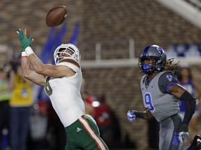 Miami's Braxton Berrios (8) reaches for a touchdown pass during the first half of an NCAA college football game as Duke's Jeremy McDuffie (9) chases in Durham, N.C., Friday, Sept. 29, 2017. (AP Photo/Gerry Broome)