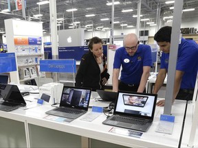 In this Tuesday, May 23, 2017, photo, employees assist a customer with a computer at Best Buy in Cary, N.C. On Wednesday, Sept. 6, 2017, the Institute for Supply Management reports on the August performance of U.S. services firms. (AP Photo/Gerry Broome)