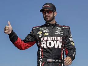 Martin Truex Jr., the playoff point leader, gestures as he is introduced prior to a NASCAR Cup Series 300 auto race at New Hampshire Motor Speedway in Loudon, N.H., Sunday, Sept. 24, 2017. (AP Photo/Charles Krupa)