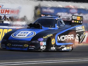 In this photo provided by the NHRA, Matt Hagan set both ends of the Funny Car track record on Friday of the Chevrolet Performance U.S. Nationals, the worlds biggest drag race, at Lucas Oil Raceway at Indianapolis. Hagan ran a 3.799-second pass at 338.77 mph during the first of three qualifying days and first of five qualifying sessions. (Marc Gerwetz/NHRA via AP)