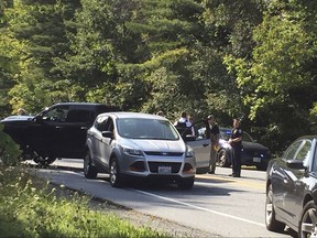 A suspect in an active shooter incident at Dartmouth-Hitchcock Medical Center was pulled from a grey Ford Escape at the intersection of LaHaye Drive and Mount Support Road in Lebanon, N.H., on Tuesday, Sept. 12, 2017. The Lebanon Department of Public Safety confirmed that someone was taken into custody shortly before 3 p.m. following reports of an active shooter at Dartmouth-Hitchcock Medical Center. (Jennifer Hauck/The Valley News via AP)