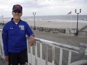 In a photo taken Thursday, Sept. 14, 2017, Frank Costello, organizer of the Semper Five charity run in Seaside Heights, N.J., poses for photograph near the site of the start and finish lines for the race. It's been a year since a pipe bomb blast disrupted the charity race to benefit Marines and marked the start of a two-day reign of terror in the region. But organizers of Saturday's race say its resumption amid tight security shows the region's resiliency. The blast occurred just before the start of last year's race. No one was injured, but the event was canceled. (AP Photo/Julio Cortez)