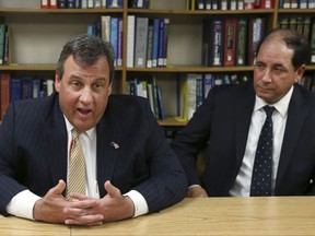 FILE - In this April 18, 2016, file photo, New Jersey Sen. Joseph F. Vitale, D-Woodbridge, right, listens as Gov. Chris Christie talks about a program that allows first responders to carry and administer medication to treat drug overdose patients in emergency situations. (AP Photo/Mel Evans, File)