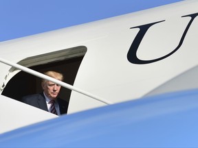 President Donald Trump steps through the door of Air Force One at Morristown Municipal Airport in Morristown, N.J., Friday, Sept. 29, 2017. Trump is spending the weekend in Bedminster, N.J., at his golf club. (AP Photo/Susan Walsh)