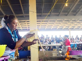 CORRECTS TO ARIZONA - In this undated photo Miss Navajo Pageant hopeful Lailauni Moore prepares fry bread after the sheep butchering competition at the Navajo Nation Fairgrounds in Window Rock, Ariz. The Miss Navajo Nation pageant is parting ways with fry bread, the fluffy, golden brown delicacy that's become a symbol of Native American culture but is rooted in oppression. Women vying for the crown this week in Window Rock will prepare traditional Navajo foods instead, like blue corn mush or a cake made at puberty ceremonies. (Adron Gardner/Gallup Independent via AP)