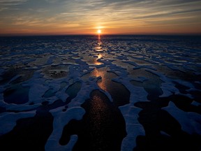 The midnight sun shines across sea ice along the Northwest Passage in the Canadian Arctic on July 22, 2017.