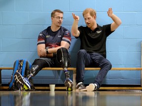 Prince Harry, right, speaks to an athlete from the volleyball team from the United Kingdom during training in the lead-up to the Invictus Games, in Toronto on Friday, Sept. 22, 2017. THE CANADIAN PRESS/Nathan Denette