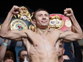 Gennady Golovkin poses on the scale during a weigh-in Friday, Sept. 15, 2017, in Las Vegas. Golovkin is scheduled to fight Canelo Alvarez in a middleweight title fight Saturday in Las Vegas. (AP Photo/John Locher)