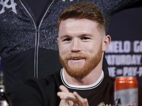 Canelo Alvarez smiles during a news conference Wednesday, Sept. 13, 2017, in Las Vegas. Alvarez is scheduled to fight Gennady Golovkin in a middleweight title fight Saturday in Las Vegas. (AP Photo/John Locher)