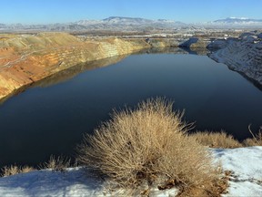 FILE - In this Jan. 2, 2013, file photo, water partially fills a huge pit left over from mining operations on the Yerington Paiute reservation in Yerington, Nev. The ground water was poisoned by the old Anaconda copper mine, which stopped production in 1978. Nevada wants to back out of an agreement with U.S. regulators to designate the toxic mine as a priority Superfund site, a move critics say could ultimately leave state taxpayers on the hook for hundreds of millions dollars in cleanup costs at the abandoned World War II-era copper mine near Yerington, according to documents obtained by The Associated Press. (Marilyn Newton/The Reno Gazette-Journal via AP, File)