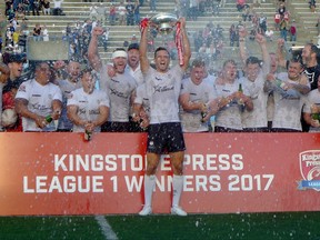 Toronto Wolfpack captain Craig Hall hoists the trophy as the first-year rugby league team celebrates winning the Kingstone Press League 1 title and promotion to the English second-tier after defeating the Barrow Raiders 26-2 at Toronto's Lamport Stadium, Saturday, September 9, 2017. THE CANADIAN PRESS/Neil Davidson