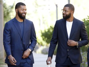 FILE in this Sept. 19, 2017 file photo, NBA players Markieff, left, and Marcus Morris arrive at Superior Court for the second day of their aggravated assault trial in Phoenix.  Jurors are expected to hear closing arguments Thursday, Sept. 28,  for the assault trial of the NBA players.  The Morris brothers are accused of helping three other people beat Erik Hood on Jan. 24, 2015. (AP Photo/Matt York, File)