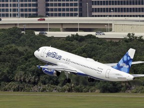 FILE - In this May 15, 2014, file photo, a JetBlue Airways Airbus A320-232 takes off from the Tampa International Airport in Tampa, Fla. Some airlines are adding flights leaving Florida as the crush to escape Irma causes a run on seats. Meanwhile, some consumers accuse the airlines of price-gouging. Several carriers responded by capping their fares from Florida.  (AP Photo/Chris O'Meara, File)