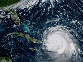 In this geocolor GOES-16 satellite image taken Thursday, Sep. 7, 2017, at 11;15 a.m. EDT, shows the eye Hurricane Irma just north of the island of Hispaniola. The fearsome Category 5 storm cut a path of devastation across the northern Caribbean, leaving at least 10 dead and thousands homeless after destroying buildings and uprooting trees on a track Thursday that could lead to a catastrophic strike on Florida. (NOAA-NASA via AP)