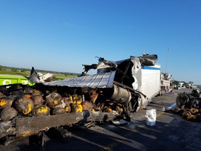 This photo provided by Florida Highway Patrol shows a truck carrying  pumpkins after hitting a guard rail on I-75  near Tampa, Fla.  The truck then exploded, spilling the burning pumpkins onto the highway.  (Florida Highway Patrol via AP)