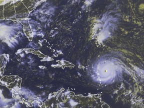In this GOES-East satellite image taken Tuesday, Sept. 5, 2017 at 3:45 p.m. EDT, and released by the National Oceanic and Atmospheric Administration (NOAA), Hurricane Irma, a potentially catastrophic category 5 hurricane, moves westward in the Atlantic Ocean toward the Leeward Islands. Hurricane Irma grew into a dangerous Category 5 storm, the most powerful seen in the Atlantic in over a decade, and roared toward islands in the northeast Caribbean Tuesday on a path that could eventually take it to the United States. (NOAA via AP)