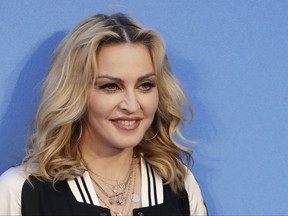 FILE - In this Sept. 15, 2016 file photo, Madonna poses for photographers upon arrival at the World premiere of the film "The Beatles, Eight Days a Week" in London.  Madonna is heading overseas to a new home in Portugal. The Michigan native had been living in New York. She said on Instagram Saturday, Sept. 2, 2017  that she finds the energy of Portugal inspiring, and it makes her feel creative and alive. (AP Photo/Kirsty Wigglesworth, File)