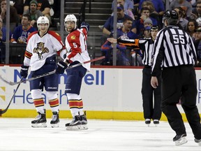 FILE - In this April 17, 2016, file photo, Florida Panthers defenseman Aaron Ekblad (5) looks back at linesman Shane Heyer (55) after scoring a goal during the second period in Game 3 of an NHL hockey first-round Stanley Cup playoff series against the New York Islanders in New York. After review, the goal was called off for offsides. The NHL has a clear message to coaches this season: Don't challenge an offside call unless you're really, really confident it was wrong. (AP Photo/Adam Hunger, File)