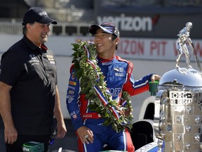 FILE - In this May 29, 2017, file photo, Indianapolis 500 champion Takuma Sato, of Japan, and car owner Michael Andretti chat during the traditional winners photo session on the start/finish line at the Indianapolis Motor Speedway in Indianapolis. Sato will return to Rahal Letterman Lanigan Racing next season. Sato spent just one season with Andretti Autosport and became the first Japanese winner of the 500. (AP Photo/Michael Conroy, File)