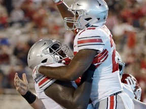 FILE - In this Aug. 31, 2017, file photo, Ohio State's Antonio Williams (26) celebrates with offensive lineman Isaiah Prince after Williams ran for a 5-yard touchdown during the second half of an NCAA college football game against Indiana, in Bloomington, Ind. Oklahoma and Ohio State will play for the fourth time and the first at the Horseshoe since the Sooners only visit in 1977. That game was, like this one between the second-ranked Buckeyes and fifth-ranked Sooners, a top-five matchup. (AP Photo/Darron Cummings, File)