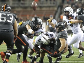 FILE - In this Sept. 9, 2017, file photo, Oregon State running back Ryan Nall, right, fumbles the ball after taking a hit from Minnesota's Thomas Barber during the second half of an NCAA college football game in Corvallis, Ore. Minnesota recovered the fumble. Minnesota, with the Big Ten's best rushing defense, plays Maryland this week. (AP Photo/Timothy J. Gonzalez, File)
