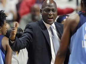 FILE - In this July 10, 2016, file photo, Atlanta Dream head coach Michael Cooper talks to players during a timeout in the second half of a WNBA game against the Connecticut Sun, in Uncasville, Conn. The Atlanta Dream have fired coach Michael Cooper after their worst season since 2008. The WNBA team announced Tuesday, Sept. 5, 2017,  that it "decided to part ways" with Cooper, the former Los Angeles Lakers star who guided the team for the last four years. (AP Photo/Jessica Hill, File)