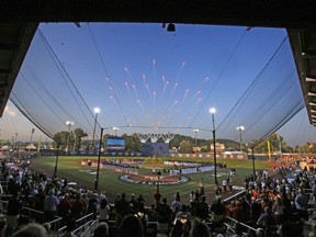 FILE - In this Aug. 20, 2017, file photo, the Pittsburgh Pirates and St. Louis Cardinals line the baselines, along with the 16 Little League teams from around the world participating in the Little League World Series Tournament that line the infield, for the national anthem before The Little League Classic baseball game between the Pirates and the Cardinals at Bowman Field in Williamsport, Pa. The New York Mets and Philadelphia Phillies will play on Aug. 19 at Bowman Field in Williamsport, under a change to next season's schedule announced Friday, Sept. 29, 2017. (AP Photo/Gene J. Puskar, File)