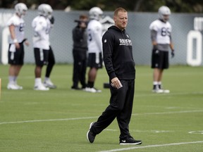 FILE - In this May 30, 2017, file photo, Oakland Raiders offensive coordinator Todd Downing watches drills during the team's organized team activity at its NFL football training facility in Alameda, Calif. Downing has spent the past two years building up a relationship with Derek Carr as his quarterbacks coach. The two play golf, talk current events and most importantly immerse themselves in all aspects of football. With Downing heading into his first game as NFL play-caller following an offseason promotion to coordinator, the hope is the strength of that relationship will pay big dividends on the field. (AP Photo/Marcio Jose Sanchez, File)