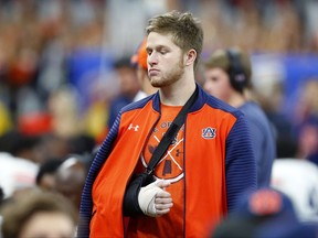 FILE - In this Jan. 2, 2017, file photo, Auburn quarterback Sean White walks on the sideline with his arm in a cast and sling in the second half of the Sugar Bowl NCAA college football game against Oklahoma in New Orleans. Auburn backup quarterback Sean White has been arrested on a charge of public intoxication. Jail records show that the 21-year-old White was taken to the Lee County Detention Center at 3:28 a.m. Sunday, Sept. 17, 2017. (AP Photo/Butch Dill, File)
