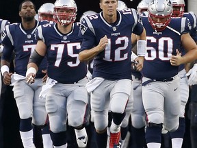 FILE - In this Aug. 10, 2017, file photo, New England Patriots quarterback Tom Brady (12) leads his team onto the field during an NFL preseason football game, in Foxborough, Mass. The Patriots moved into elite company with their fifth Super Bowl title last season, joining the Dallas Cowboys and San Francisco 49ers at five Lombardi trophies each. New England lost a few pieces from their 2016 championship run, but return with a mostly intact lineup, led by what seems like an ageless quarterback in Tom Brady, even at 40 years old. . It makes them to odds on favorite to tie the Pittsburgh Steelers and their record six Super Bowl crowns. (AP Photo/Mary Schwalm, File)