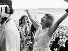 FILE - This June 9, 1973, file photo shows Penny Chenery, owner of Secretariat, reacting after her horse won the Belmont Stakes, and the Triple Crown, at Belmont Park in Elmont, N.Y. Chenery, who bred and raced 1973 Triple Crown winner Secretariat as well as realizing her disabled father's dream to win the Kentucky Derby in 1972 with Riva Ridge, died Saturday, Sept. 16, 2017, at her Boulder, Colo. home following complications from a stroke, her children announced Sunday through Leonard Lusky, her longtime friend and business partner. She was 95.  (AP Photo/Jack Kanthal, File)