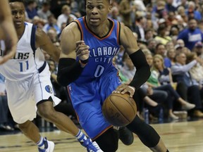 File-This photo taken March 27, 2017, shows Oklahoma City Thunder guard Russell Westbrook (0) dribbling during the first half of an NBA basketball game against the Dallas Mavericks in Dallas. Westbrook has yet to sign an extension, but the reigning league MVP said Oklahoma City is where he wants to be and he is "happy" about the offseason additions of superstars Carmelo Anthony and Paul George. "I love it here," he said. "I like where I'm at, and I like where our team is at."(AP Photo/LM Otero, File)