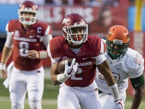 FILE - In this Aug. 31, 2017, file photo, Arkansas running back Chase Hayden (2) runs down the field as Florida A&M defensive end Atreus Martin (92) pursues during an NCAA college football game in Little Rock, Ark. Arkansas plays TCU this week. The Horned Frogs are so loaded at linebacker that Ty Summers was moved to end a year after ranking second on the team and in the Big 12 with 121 tackles. With the quick emergence of true freshman Hayden (120 yards on 14 carries in his debut) and addition of South Carolina transfer David Williams, the Razorbacks have three solid runners .(AP Photo/Gareth Patterson, File)