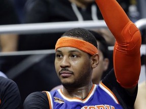 FILE - In this March 1, 2017, file photo New York Knicks' Carmelo Anthony waves to fans cheering his name during the final moments of an NBA basketball game against the Orlando Magic in Orlando, Fla. The Knicks agreed to trade Anthony to the Thunder on Saturday, Sept. 23, 2017, saving themselves a potentially awkward reunion next week with the player they'd been trying to deal since last season.  New York will get Enes Kanter, Doug McDermott and a draft pick, a person with knowledge of the deal said. The person spoke with The Associated Press on condition of anonymity because the trade had not been announced.  (AP Photo/John Raoux, File)