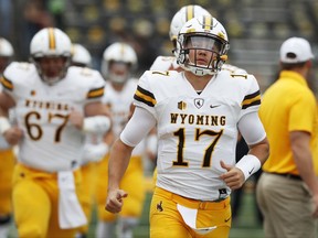 FILE - In this Saturday, Sept. 2, 2017, file photo, Wyoming quarterback Josh Allen (17) runs onto the field before an NCAA college football game against Iowa in Iowa City, Iowa. Allen had a long day against Iowa and it got even worse against Oregon. The Wyoming quarterback's two big chances to show off his prodigious talents were pretty much a flop, but make no mistake: Allen is still one of the most talented college quarterbacks in the country and a potential high draft pick. (AP Photo/Charlie Neibergall, File)