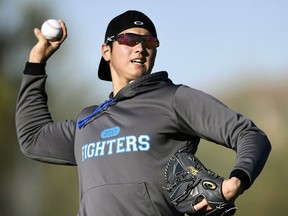 FILE - In this Jan. 31, 2017, file photo, Japanese baseball player Shohei Otani pitches the ball during the Nippon Ham Fighters' spring camp in Peoria, Ariz. Shohei Otani is likely to leave Japan and sign with a Major League Baseball team after this season, multiple reports in Japanese media said Wednesday, Sept. 13, 2017, a move that would cost the 23-year-old pitcher and outfielder more than $100 million. (Junko Ozaki/Kyodo News via AP, File)