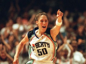 FILE - In this June 19, 1997, file photo, New York Liberty's Rebecca Lobo gestures in the closing moments of New York's 65-57 WNBA victory over the Phoenix Mercury at New York's Madison Square Garden. Lobo says she first realized she was part of something historic when she began seeing young boys wearing her New York Liberty jersey.  Lobo, who helped popularize women's basketball at UConn and later in the first years of the WNBA will be enshrined in the Hall of Fame on Friday, Sept. 8, 2017, about 12 miles from where she grew up in Massachusetts. (AP Photo/Bill Kostroun, File)