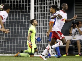 FILE - In this Aug. 15, 2017, file photo, New York Red Bulls forward Bradley Wright-Phillips, right, celebrates after scoring on FC Cincinnati goalkeeper Mitch Hildebrandt, center left, in  the second overtime of a U.S. Open Cup semifinal soccer match in Cincinnati. Sporting Kansas City host the New York Red Bulls in the U.S Open Cup final on Wednesday, Sept. 20, 2017. (AP Photo/John Minchillo, File)