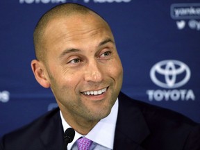 FILE - In this Sept. 28, 2014, file photo, New York Yankees' Derek Jeter speaks to the media after the last baseball game of his career, against the Boston Red Sox, at Fenway Park in Boston. Derek Jeter and Bruce Sherman are holding meetings Tuesday and Wednesday, Sept. 5-6, 2017,  at Marlins Park to ease the transition in their investment group's pending purchase of the Miami Marlins, a person familiar with the discussions said. The person confirmed the meetings to The Associated Press on condition of anonymity because those involved have not commented. (AP Photo/Steven Senne, File)