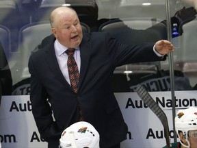 FILE - In this Oct. 4, 2016, file photo, Minnesota Wild head coach Bruce Boudreau directs his players in the second period of an NHL preseason hockey game against the Colorado Avalanche in Denver. The Wild start their second season under Boudreau, with the grueling conditioning test designed to set the tone for the up-tempo style Boudreau wants his team to play. (AP Photo/David Zalubowski, File)