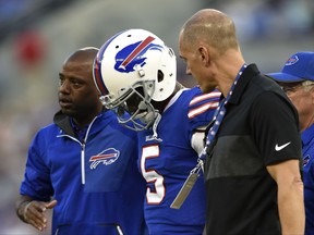 FILE - In this Aug. 26, 2017, file photo, Buffalo Bills quarterback Tyrod Taylor (5) is assisted off the field after being sacked by Baltimore Ravens linebacker Matt Judon in the first half of a preseason NFL football game, in Baltimore. Taylor is still recovering from a concussion, leaving his status uncertain for the team's season opener against the New York Jets on Sunday. Coach Sean McDermott said Monday, Sept. 4, 2017, that Taylor has shown signs of improvement but remains in the NFL's concussion protocol.(AP Photo/Gail Burton, File)