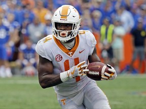 FILE- In this Saturday, Sept. 16, 2017, file photo, Tennessee running back John Kelly runs against Florida during the second half of an NCAA college football game in Gainesville, Fla. The Southeastern Conference has three of the four running backs on the Associated Press preseason All-America team. Yet three weeks into the season, the SEC's leading rusher is Tennessee's John Kelly. (AP Photo/John Raoux, File)